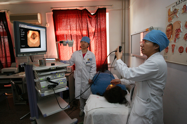 专家正在使用olympus电子喉镜给病人检查图